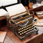Assembled wooden typewriter on a writing desk for scale