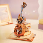 The Soloist wooden cello music box kit, assembled with the movement visible