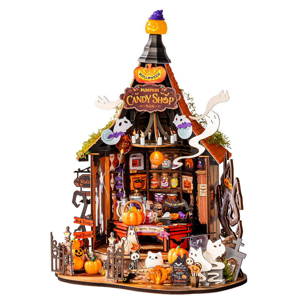 Assembled candy house on a bookshelf for scale