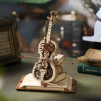 Acrylic bow on the natural wood cello music box, mid-travel